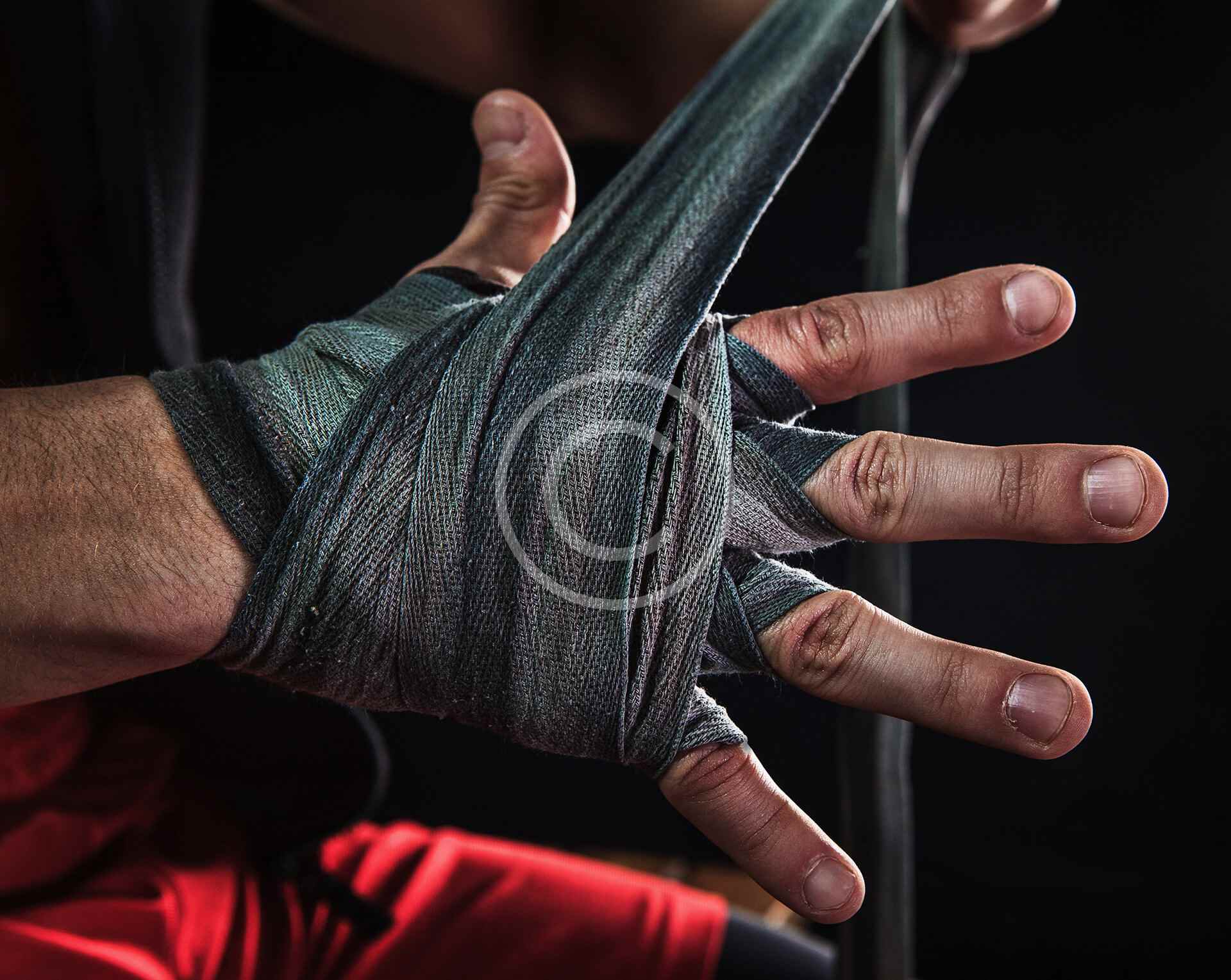 Close-up of protective gloves and wrist support equipment on hands.