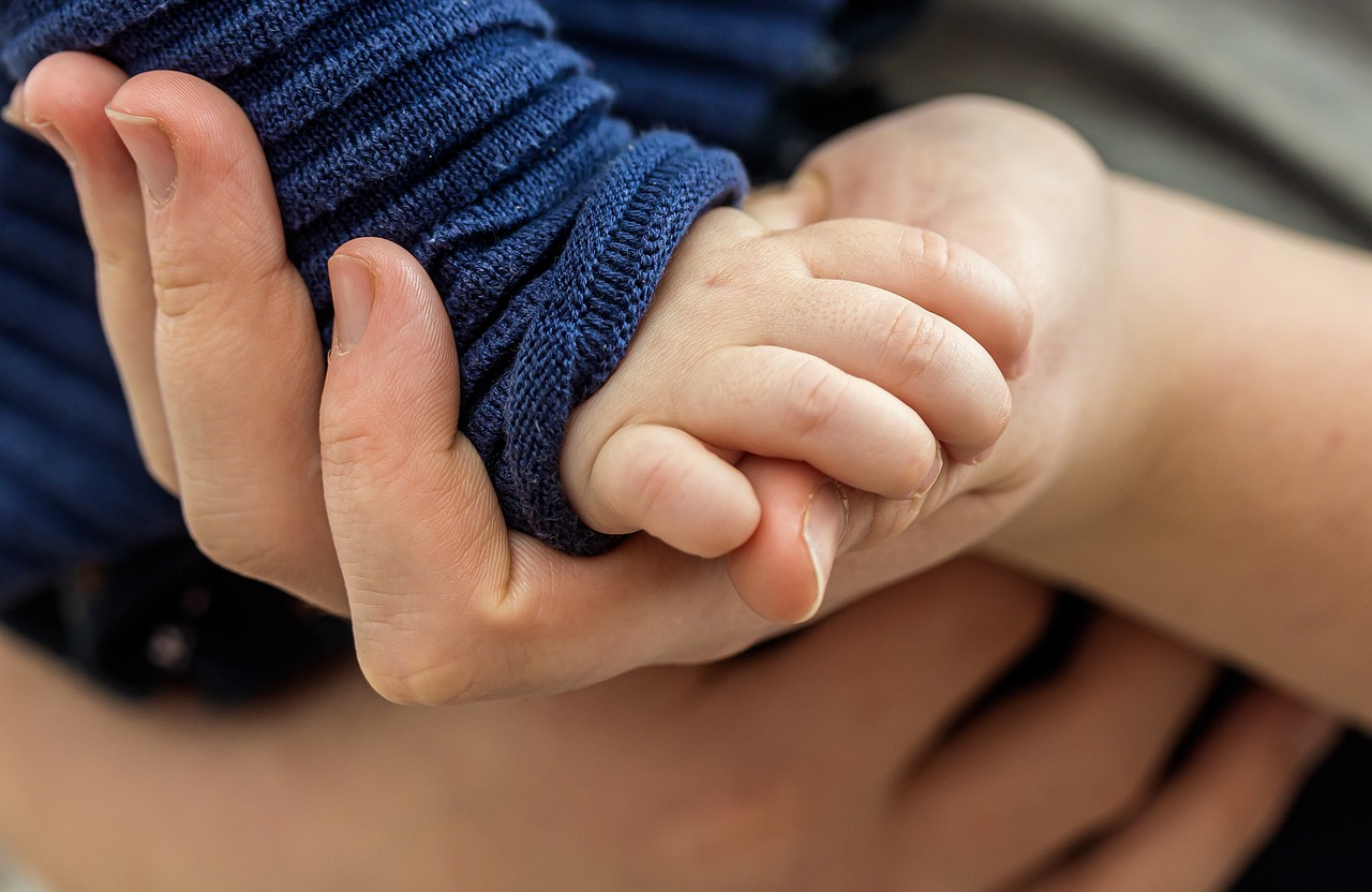 Close-up of chalk-covered hands gripping a barbell