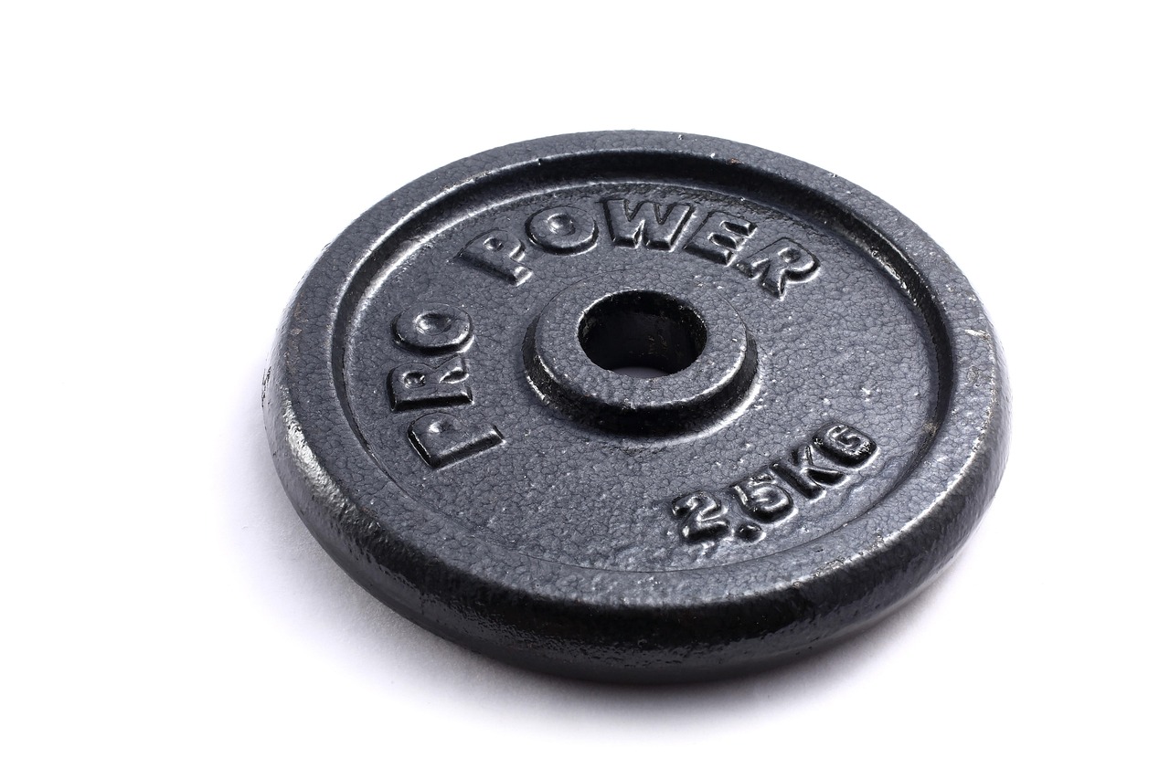 Iron weight plates stacked on a barbell